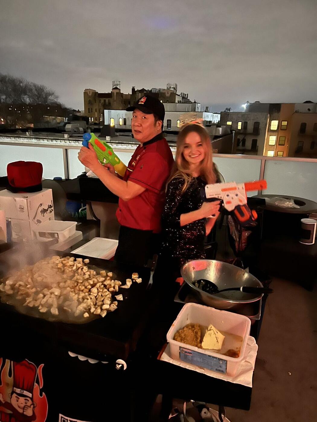 Hibachi chef cooking at a nighttime backyard party on Long Island
