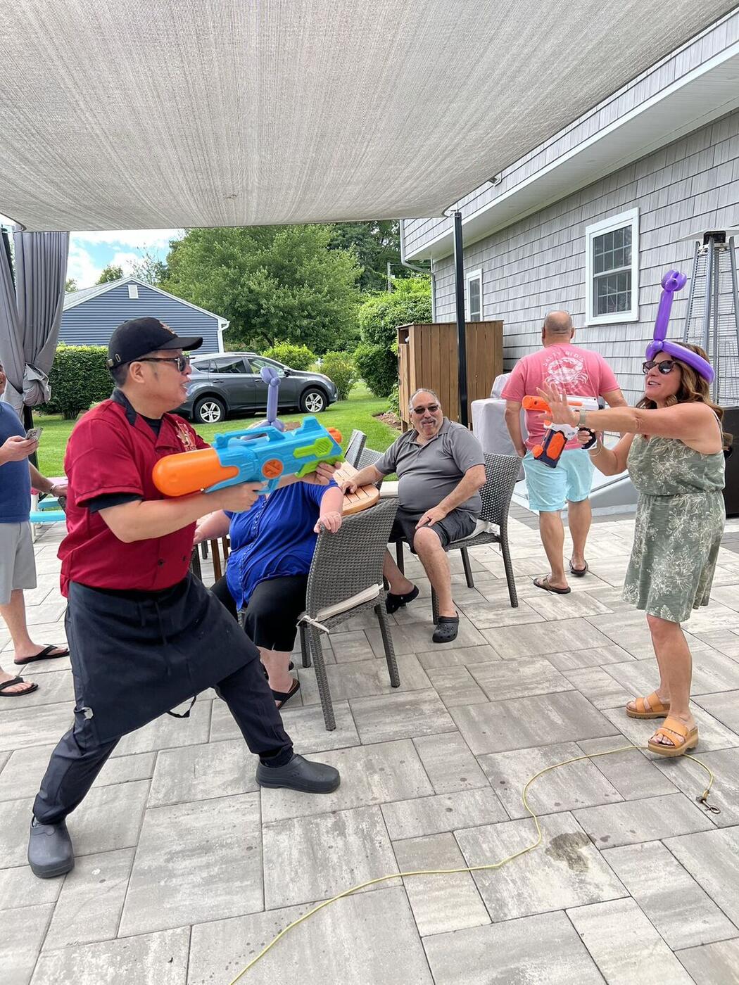 Hibachi chef entertaining guests on a patio at a Long Island hibachi party
