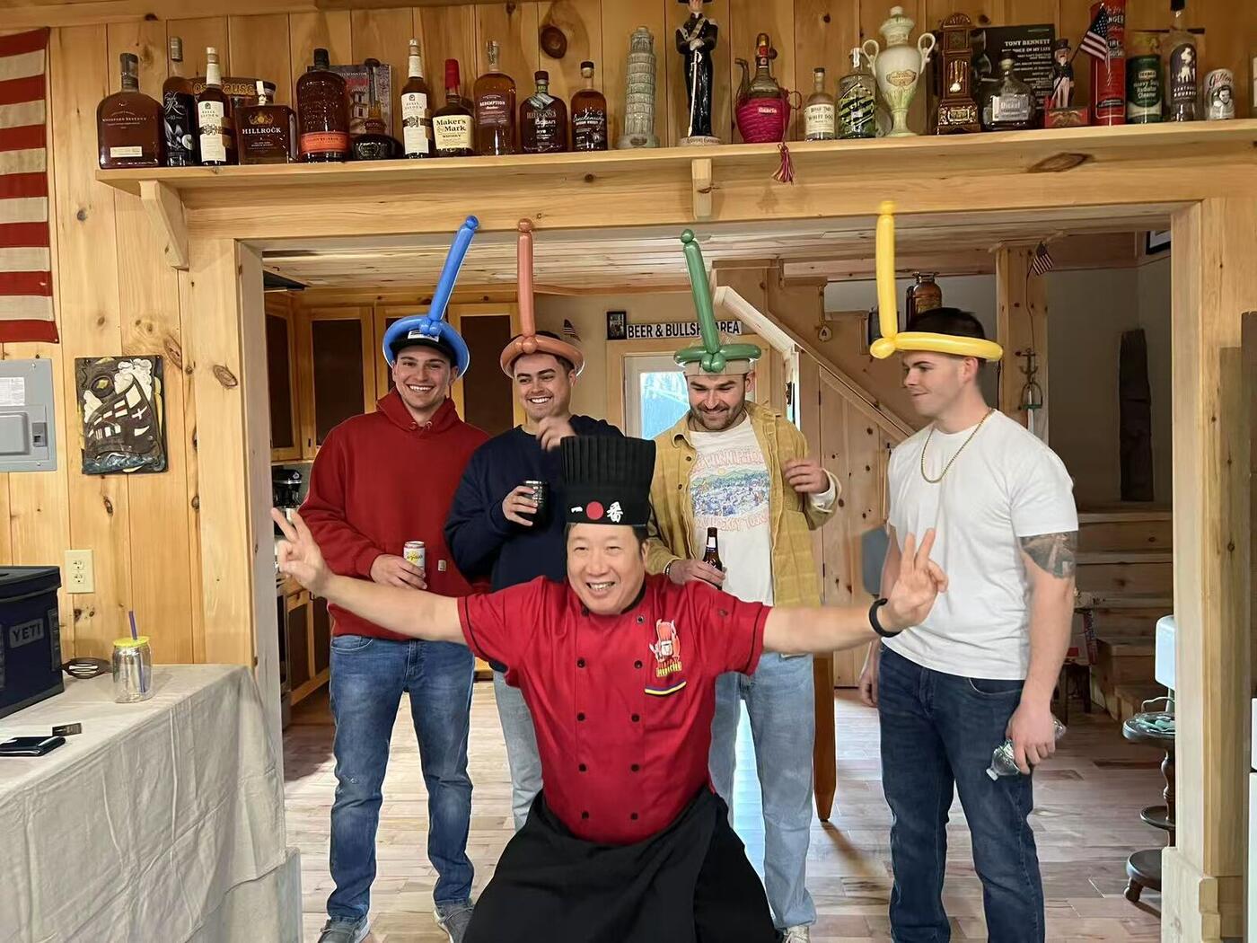Happy Hibachi chef celebrating with guests at a Long Island home party