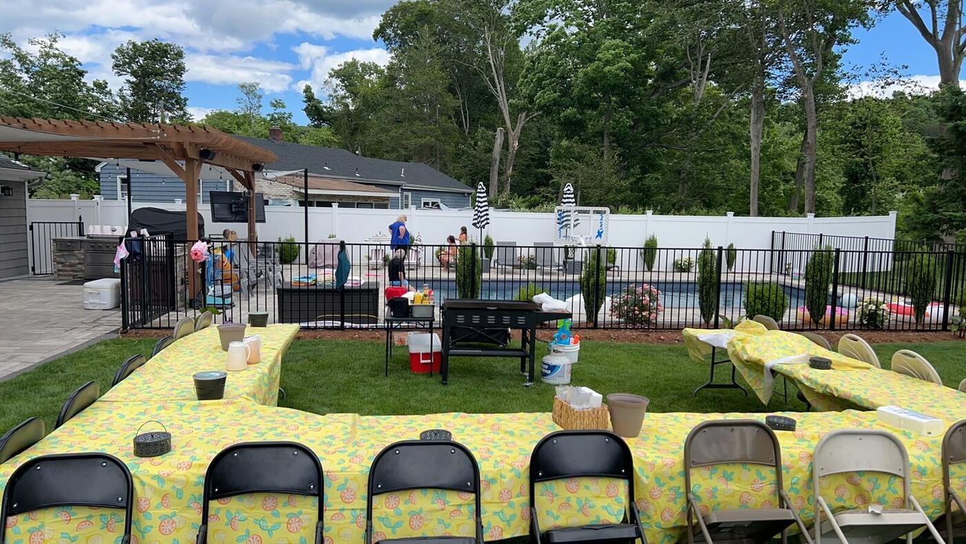 U-shaped table setup for a large hibachi party in a Long Island backyard